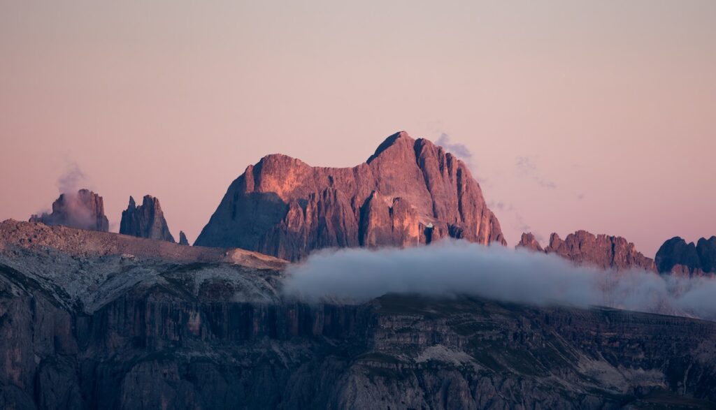 Jagged mountain peaks illuminated by soft sunset light